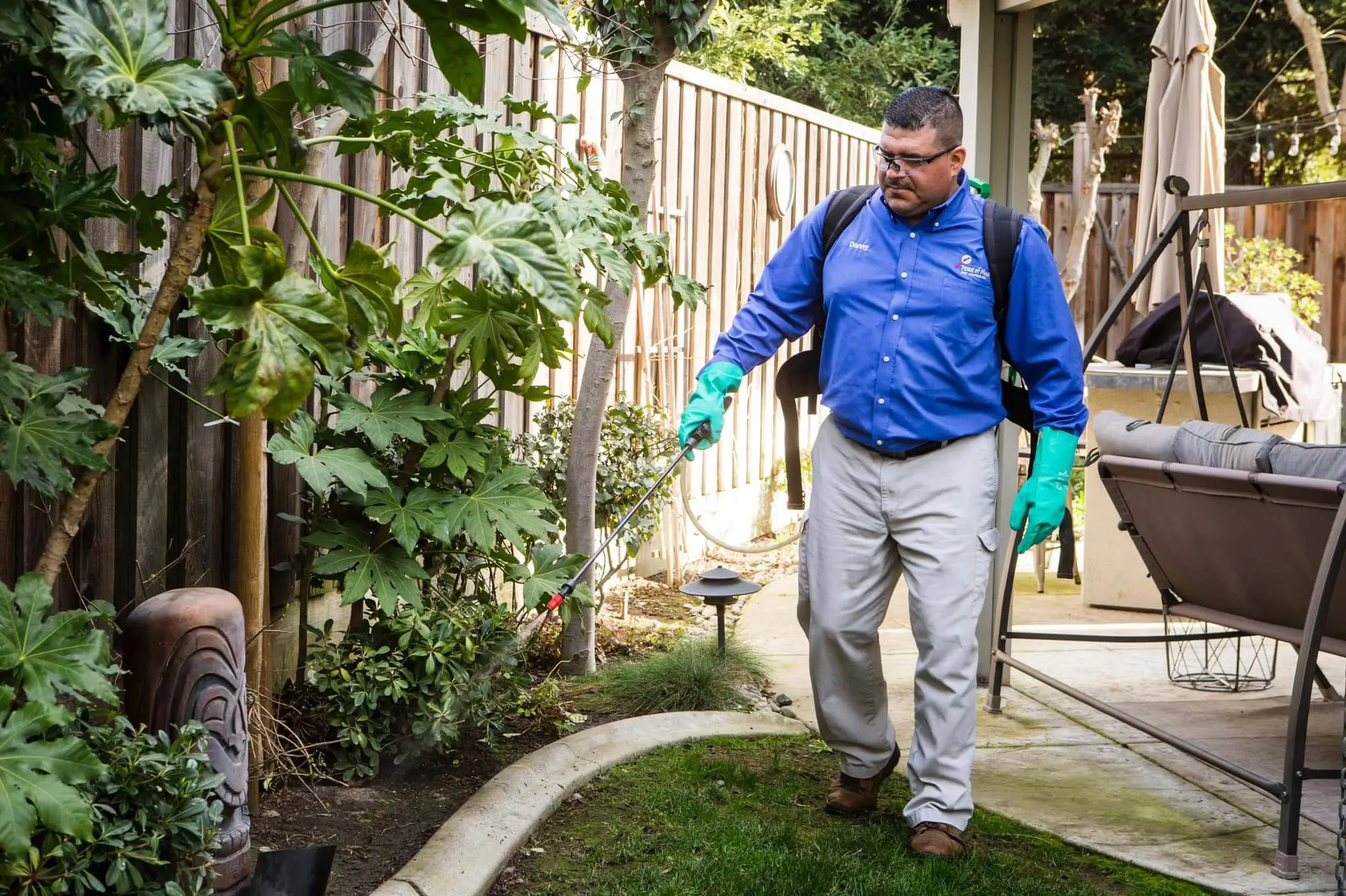 Pest control technician working in a yard
